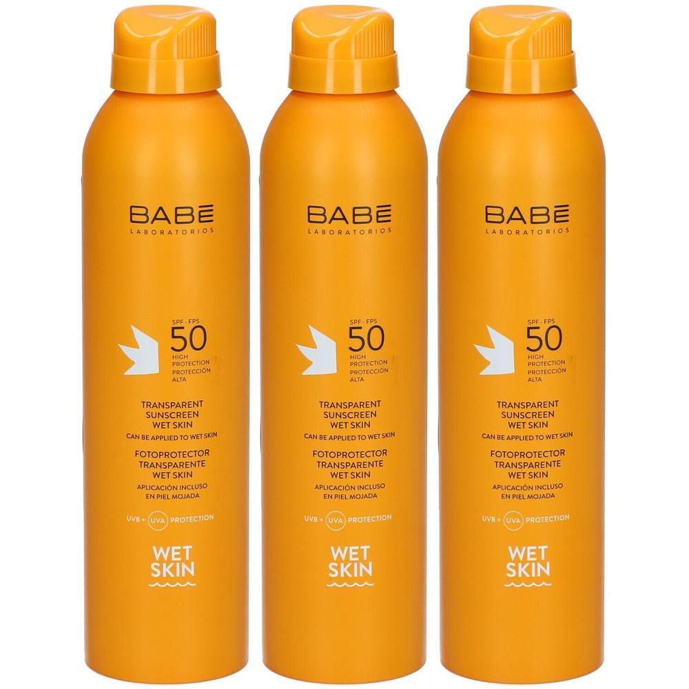 Drie oranje spuitbussen BABÉ Transparent Sunscreen Wet Skin SPF50.