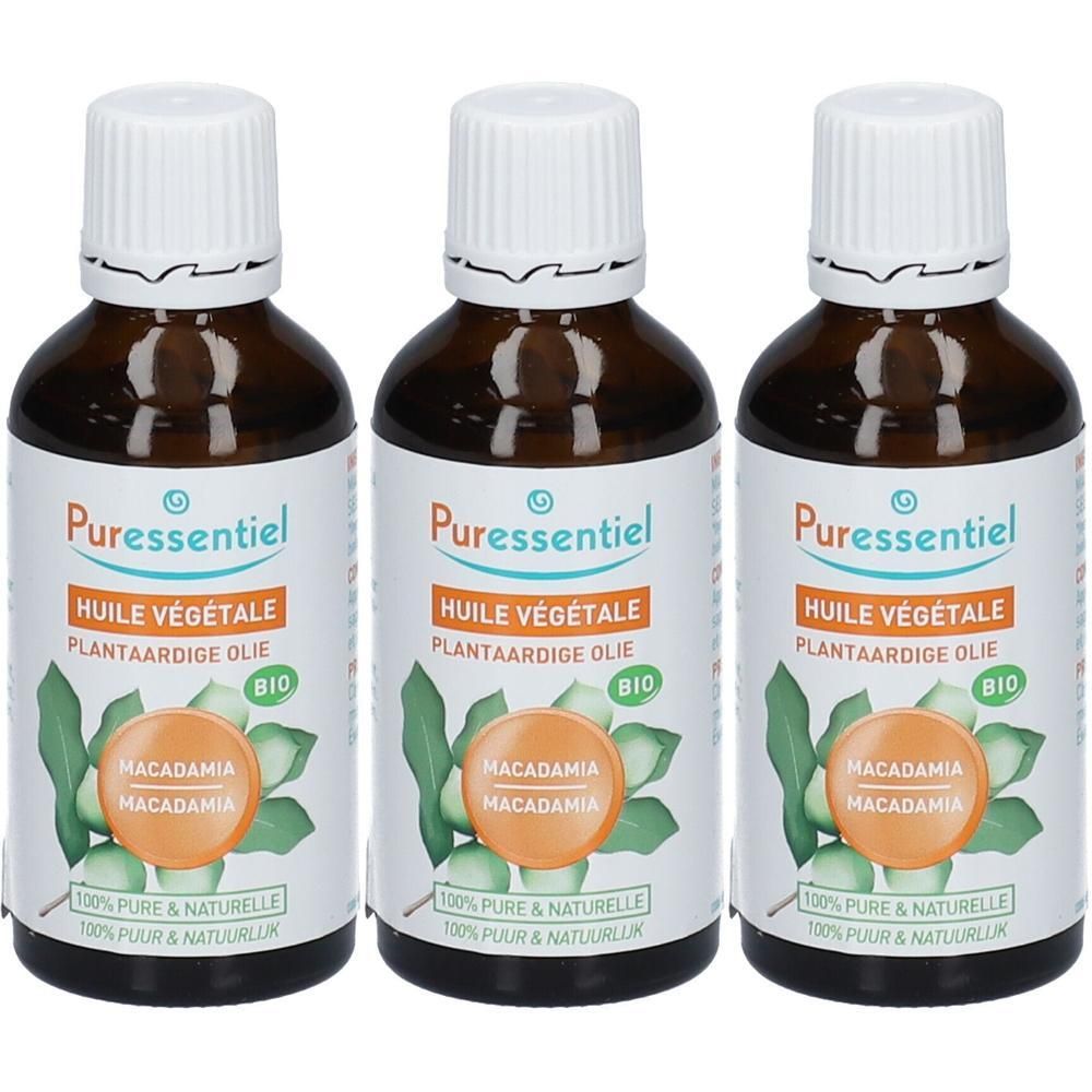 Drie flessen Puressentiel macadamia plantaardige olie. Bruine glazen flessen met witte doppen.