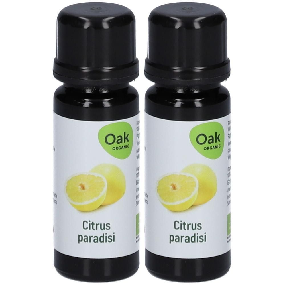 Deux flacons d'huile essentielle Oak Organic Citrus paradisi. Illustration de pamplemousse.