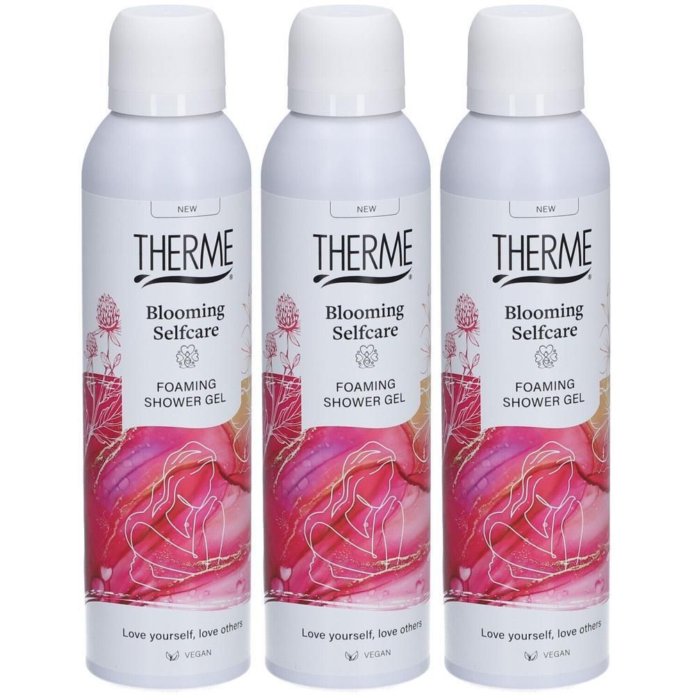 Trois flacons blancs de gel douche moussant Therme Blooming Selfcare, décorés de motifs floraux roses et dorés.