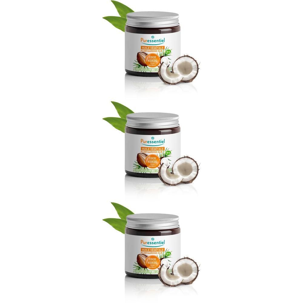 Drie potjes kokosolie met kokoshelften en bladeren.