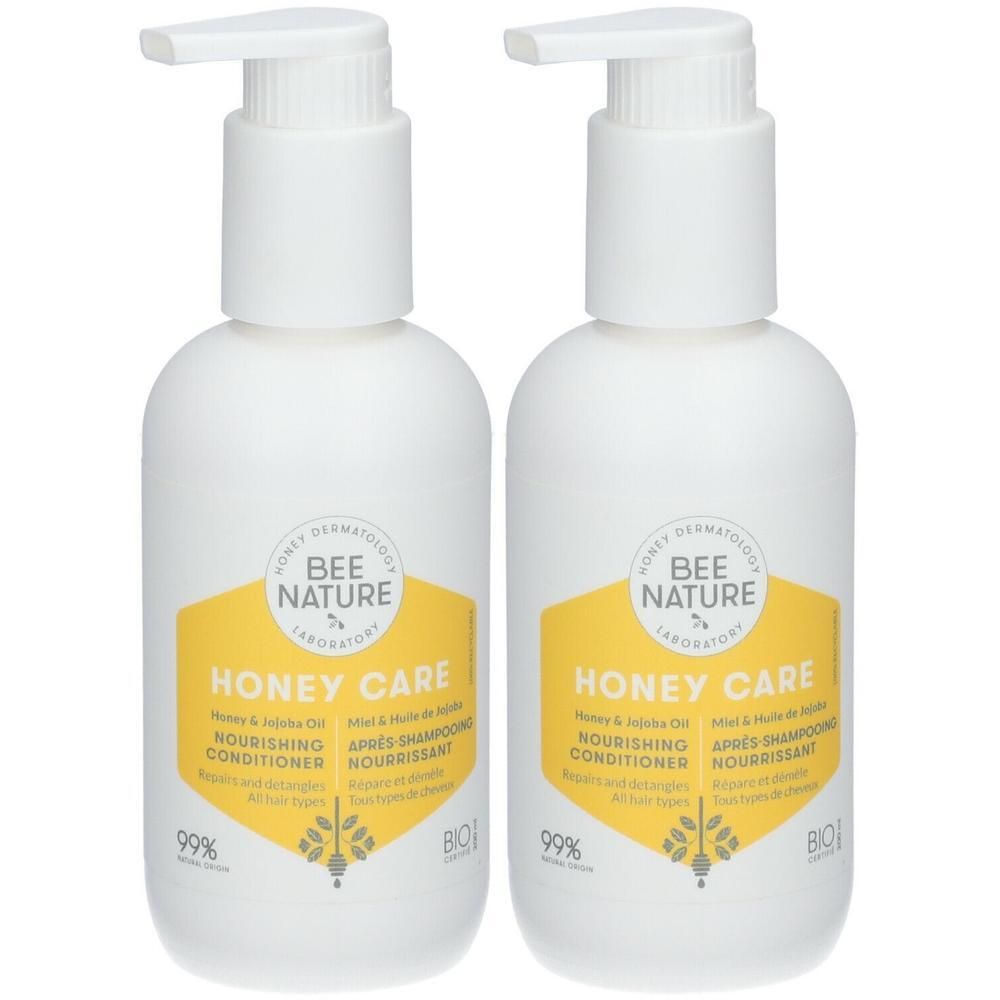 Deux flacons pompe blancs avec étiquette jaune, Bee Nature Honey Care.