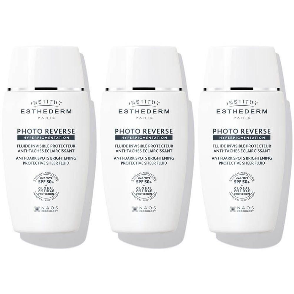Trois flacons blancs Institut Esthederm Photo Reverse avec distributeur.