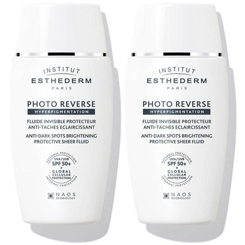 Twee witte flacons Institut Esthederm Photo Reverse Anti-Dark Spots Brightening Protective Sheer Fluid SPF 50+.