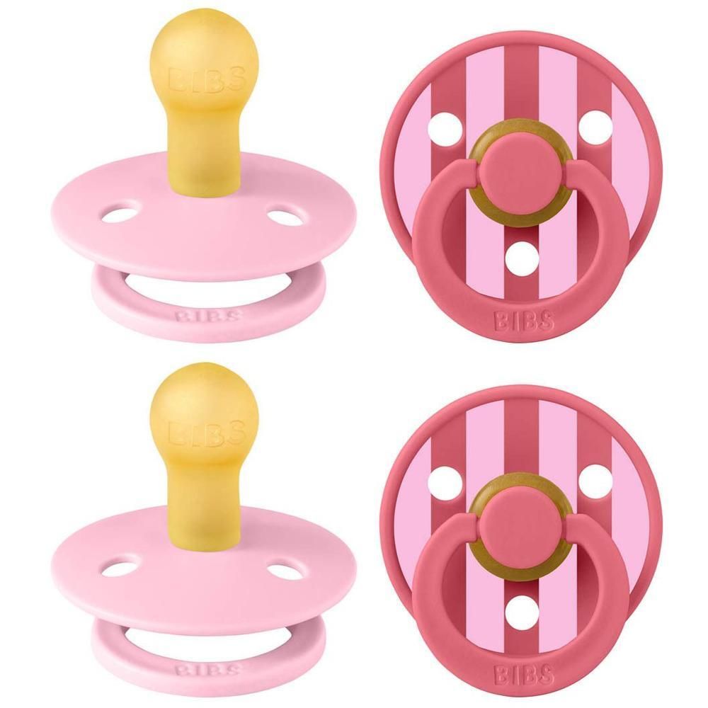 Deux sucettes BIBS roses avec tétine en caoutchouc naturel jaune et anneau rose.