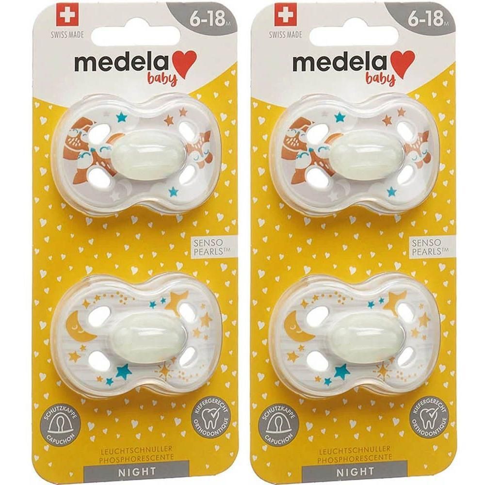 Deux sucettes Medela Baby Night, 6-18 mois, avec étoiles et lunes phosphorescentes.