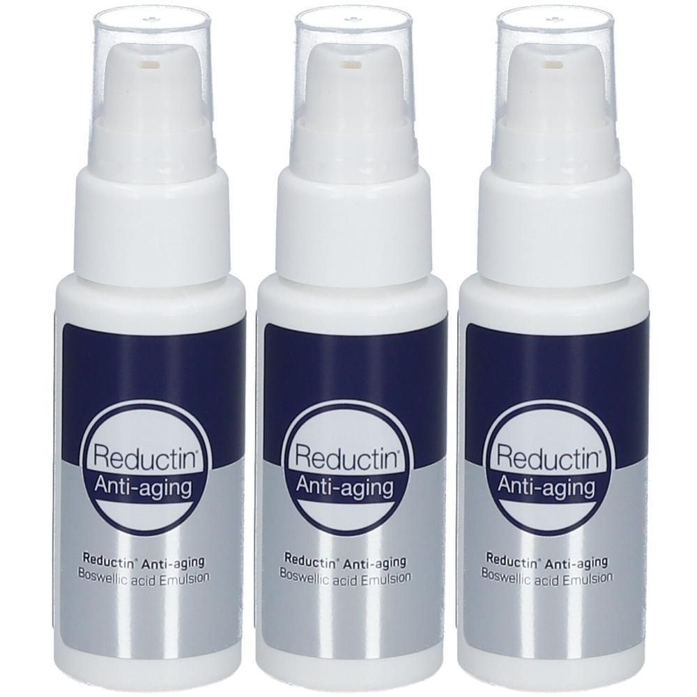 Trois flacons pompe blancs avec étiquette bleu foncé, marqués "Reductin Anti-aging Boswellic Acid Emulsion".