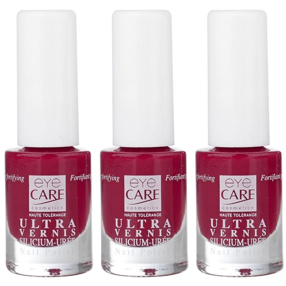 Drie flacons Eye Care Ultra Vernis nagellak in donkerrood met witte dopjes.