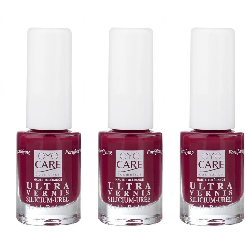 Trois flacons de vernis à ongles Eye Care Ultra Vernis couleur framboise avec bouchons blancs. Flacons en verre avec étiquettes.