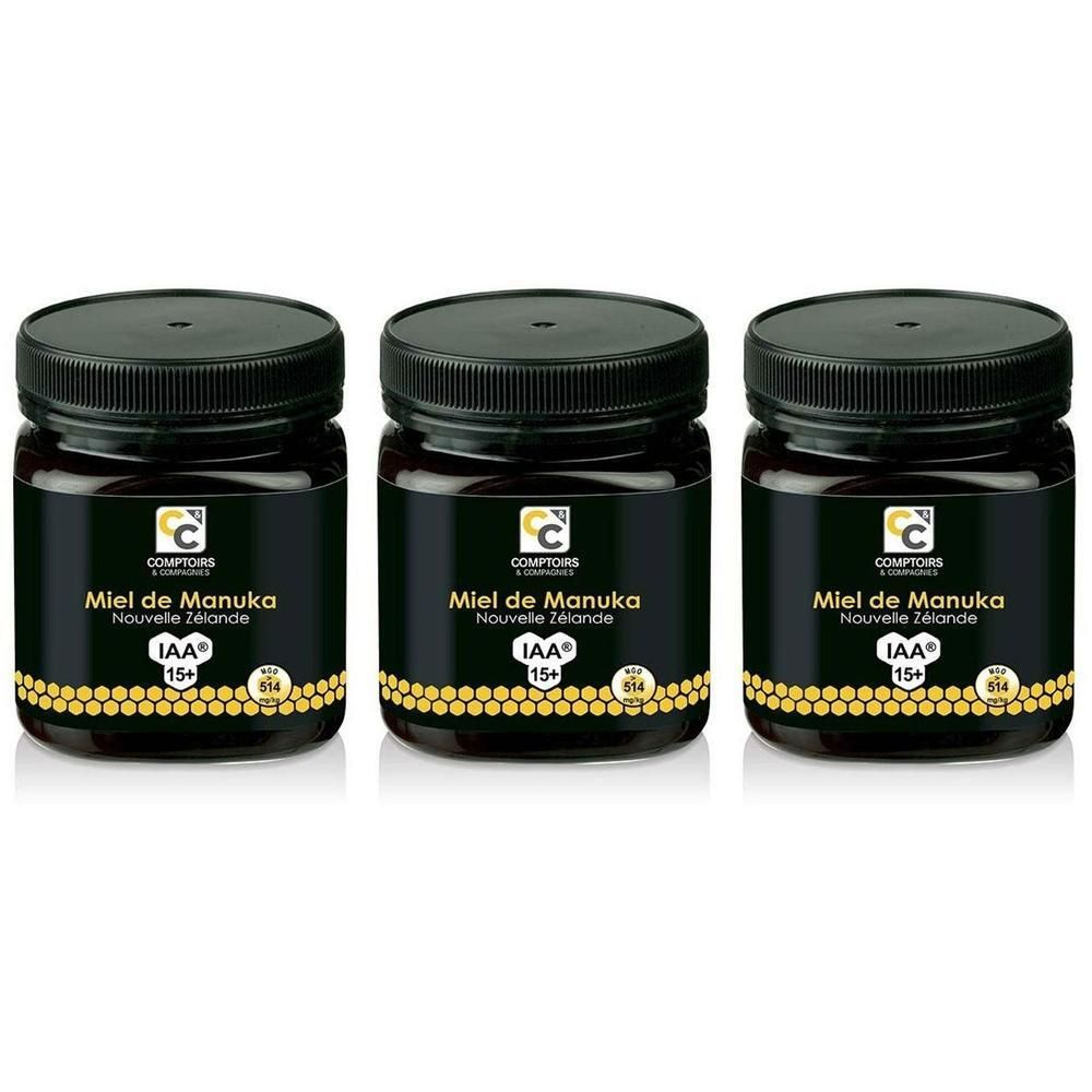 Trois pots de miel de Manuka IAA 15+ avec couvercles et étiquettes noirs.
