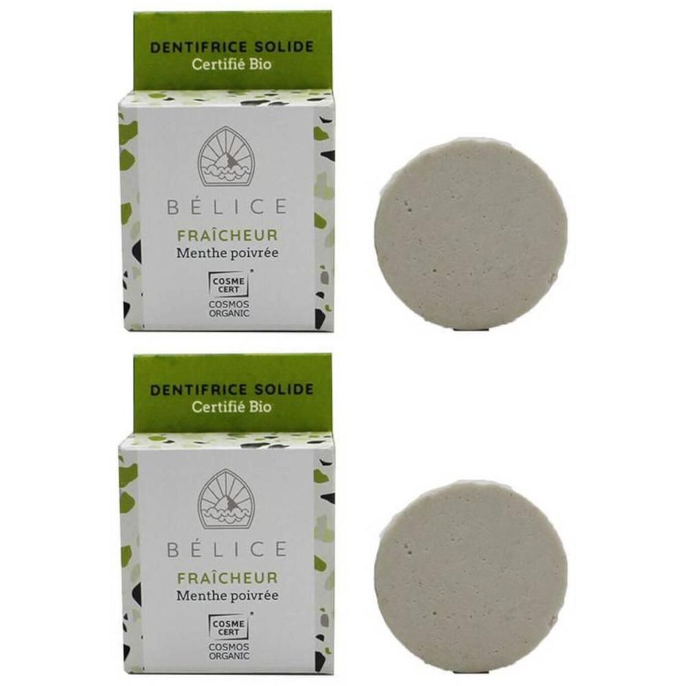 Deux pastilles de dentifrice solide rondes et leurs emballages. Certifié Bio.