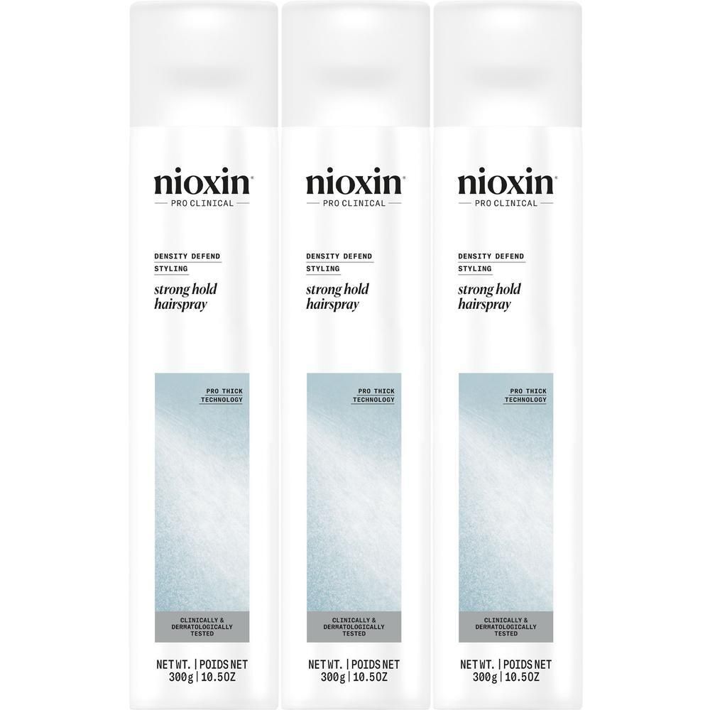 Trois canettes de spray capillaire Nioxin Strong Hold côte à côte.