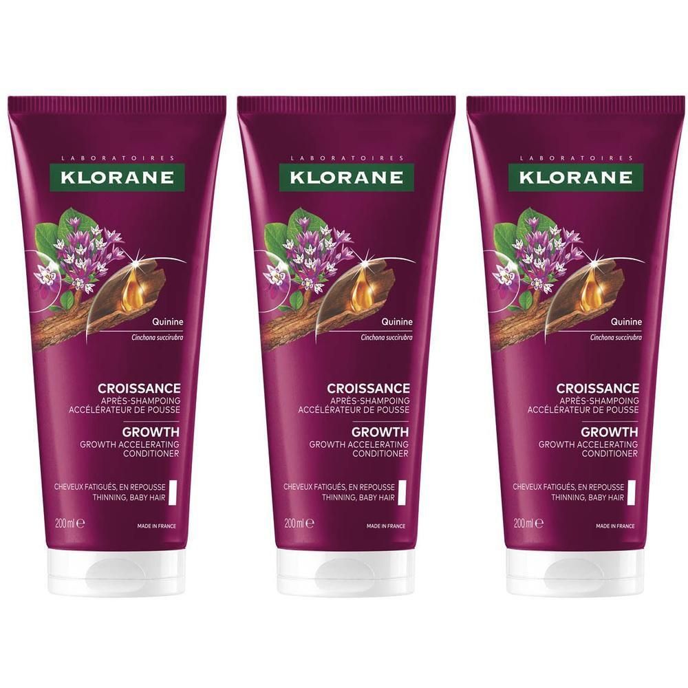 Drie Klorane Groei Conditioner tubes met kinine-extract en paarse bloemen.