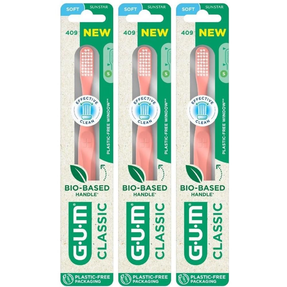 Drie GUM Classic Compact Soft tandenborstels in roze, in plasticvrije verpakking.