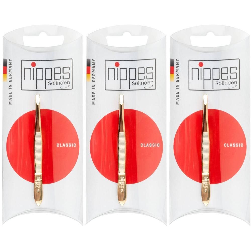 Trois pinces à épiler Nippes dorées, modèle "Classic", sous emballage.