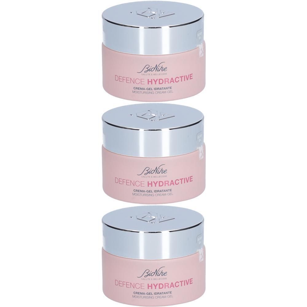 Trois BioNike Defence Hydractive Crème-Gel hydratante dans des pots roses avec des couvercles argentés.