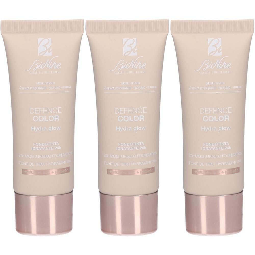 Drie tubes BioNike Defence Color Hydra Glow Foundation in Beige.