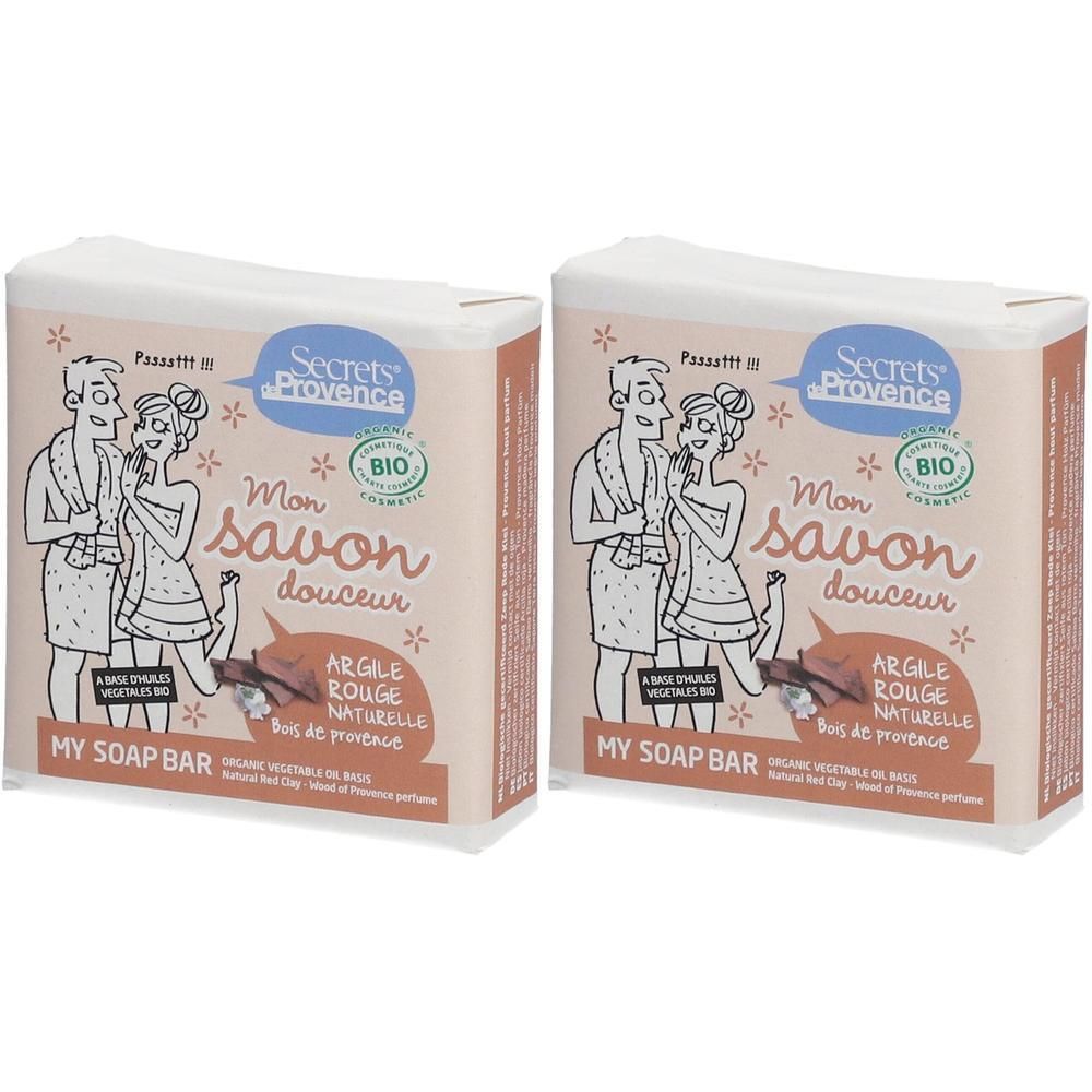 Twee pakken zeep met rode klei en bio-keurmerk. Toont een stel in badjassen.