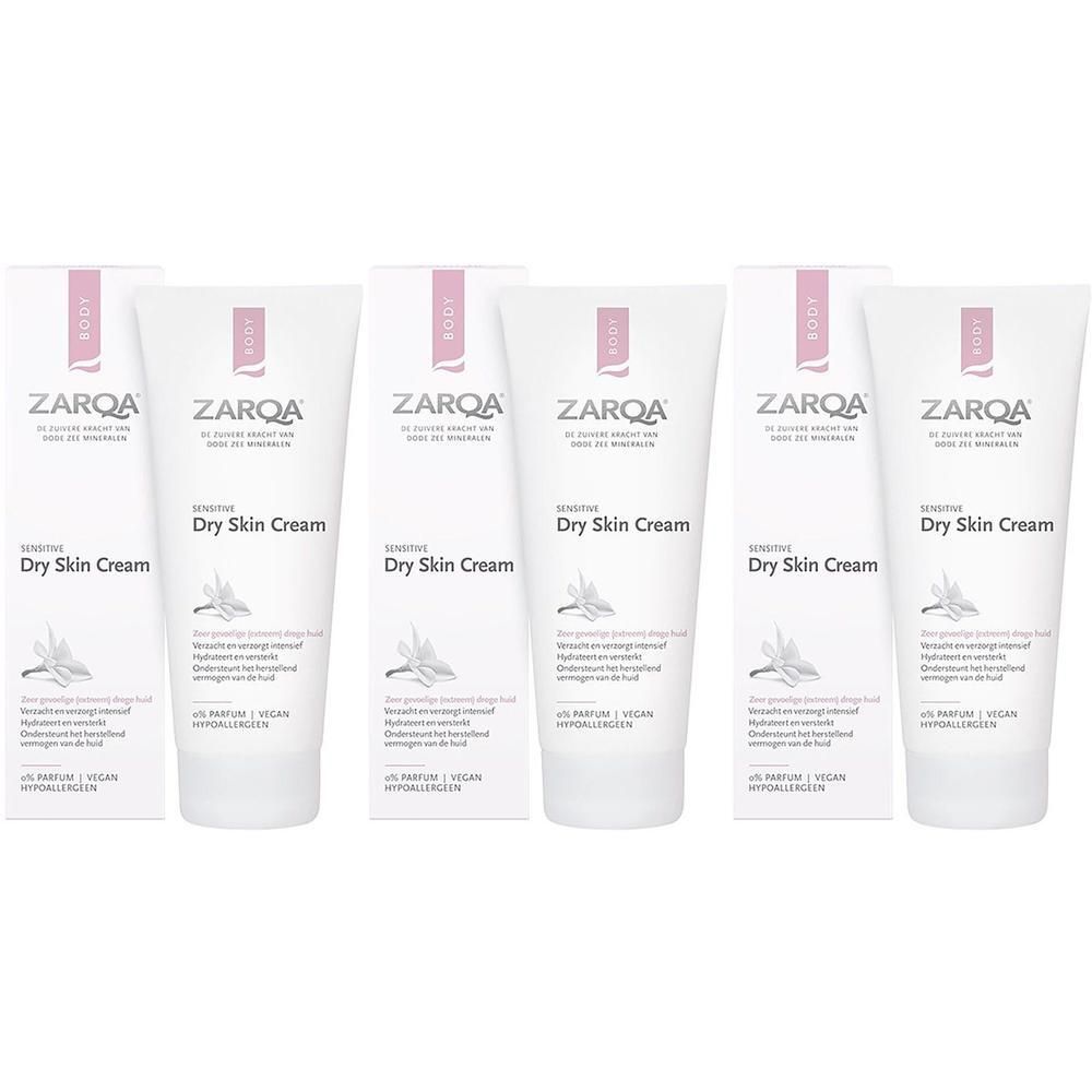Zes Zarqa Dry Skin Cream tubes en doosjes, wit met roze accenten.