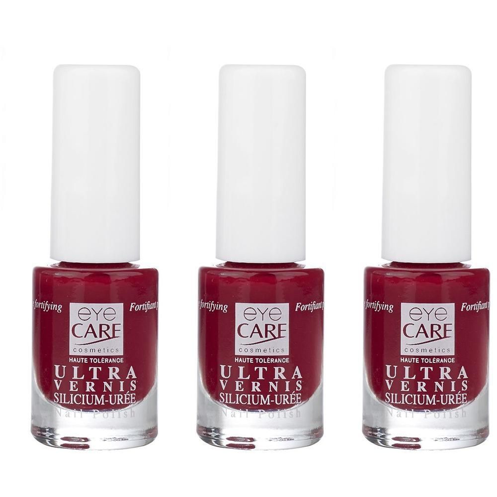 Trois flacons de vernis à ongles Eye Care Ultra Vernis rouge. Flacons en verre transparent avec bouchons blancs.