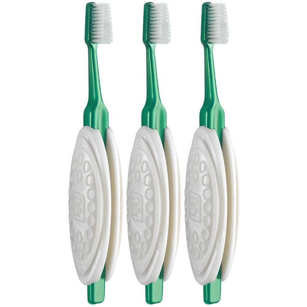 Trois brosses à dents vertes avec manches et têtes blanches.