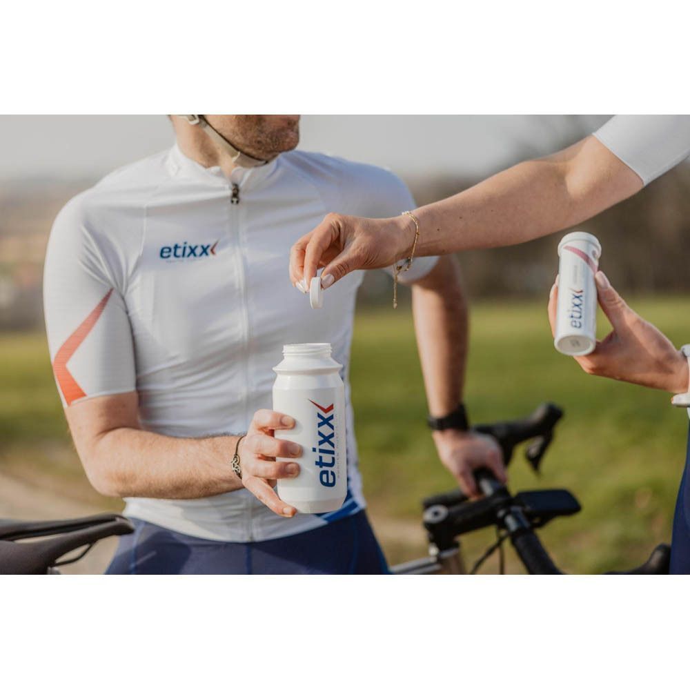 Sporter maakt Etixx Isotonic Drink Tabs Citroen aan in een drinkfles. Etixx drinkfles zichtbaar.