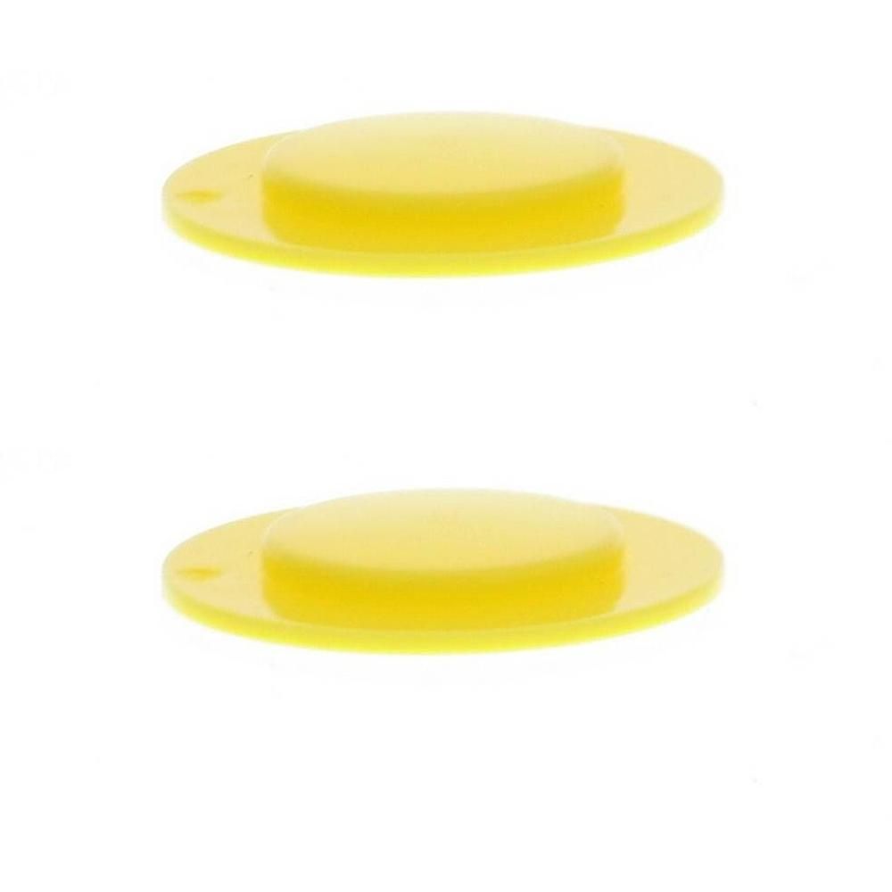 Deux coussinets jaunes pour armatures de soutien-gorge, ovales avec un centre surélevé.