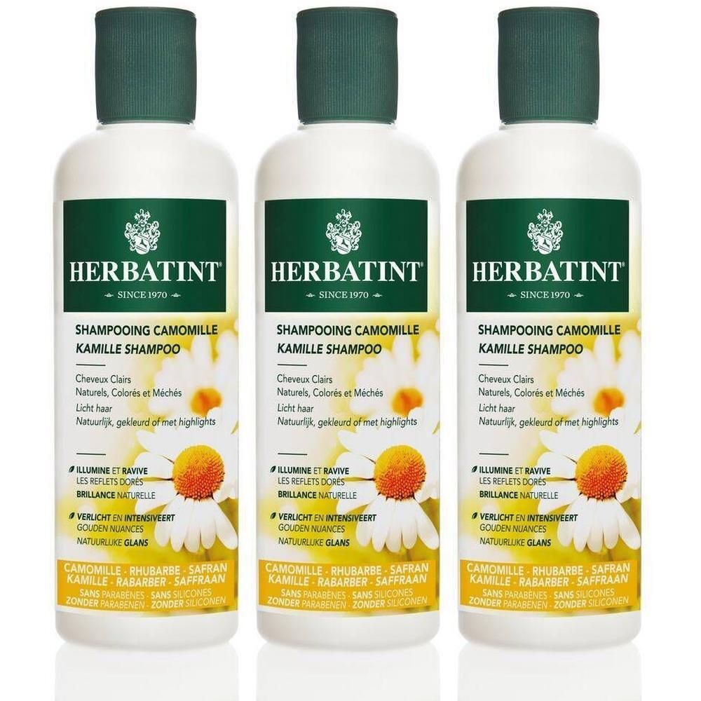 Trois bouteilles de shampoing Herbatint à la camomille, avec motif de fleurs de camomille.
