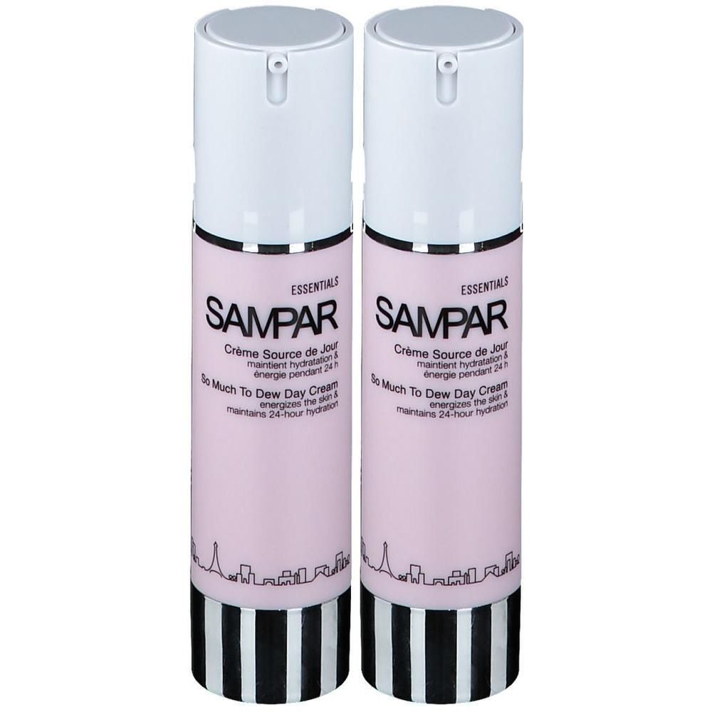 Twee Sampar Crème Source de Jour flessen met pompdos. Roze etiketten met zwarte en witte tekst.