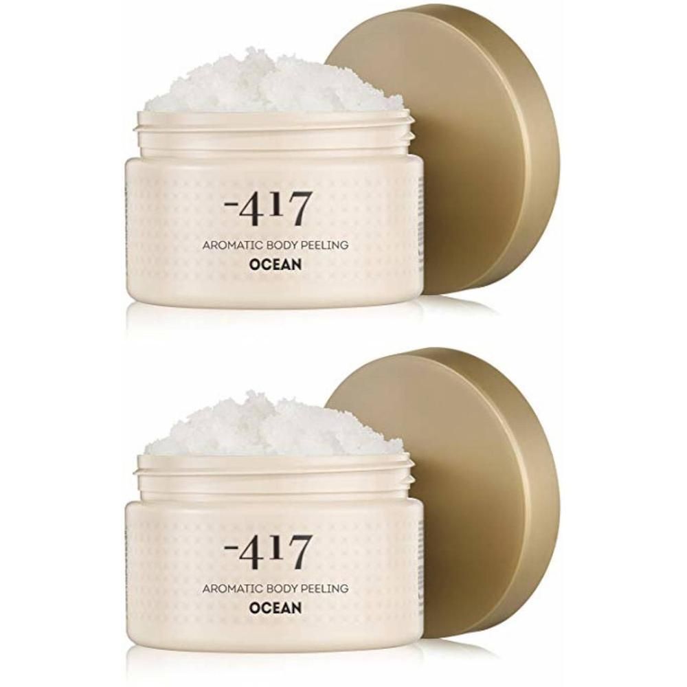 Twee potten Minus 417 Body Scrub "Ocean". Witte scrubmassa in crèmekleurige potjes met gouden deksels.