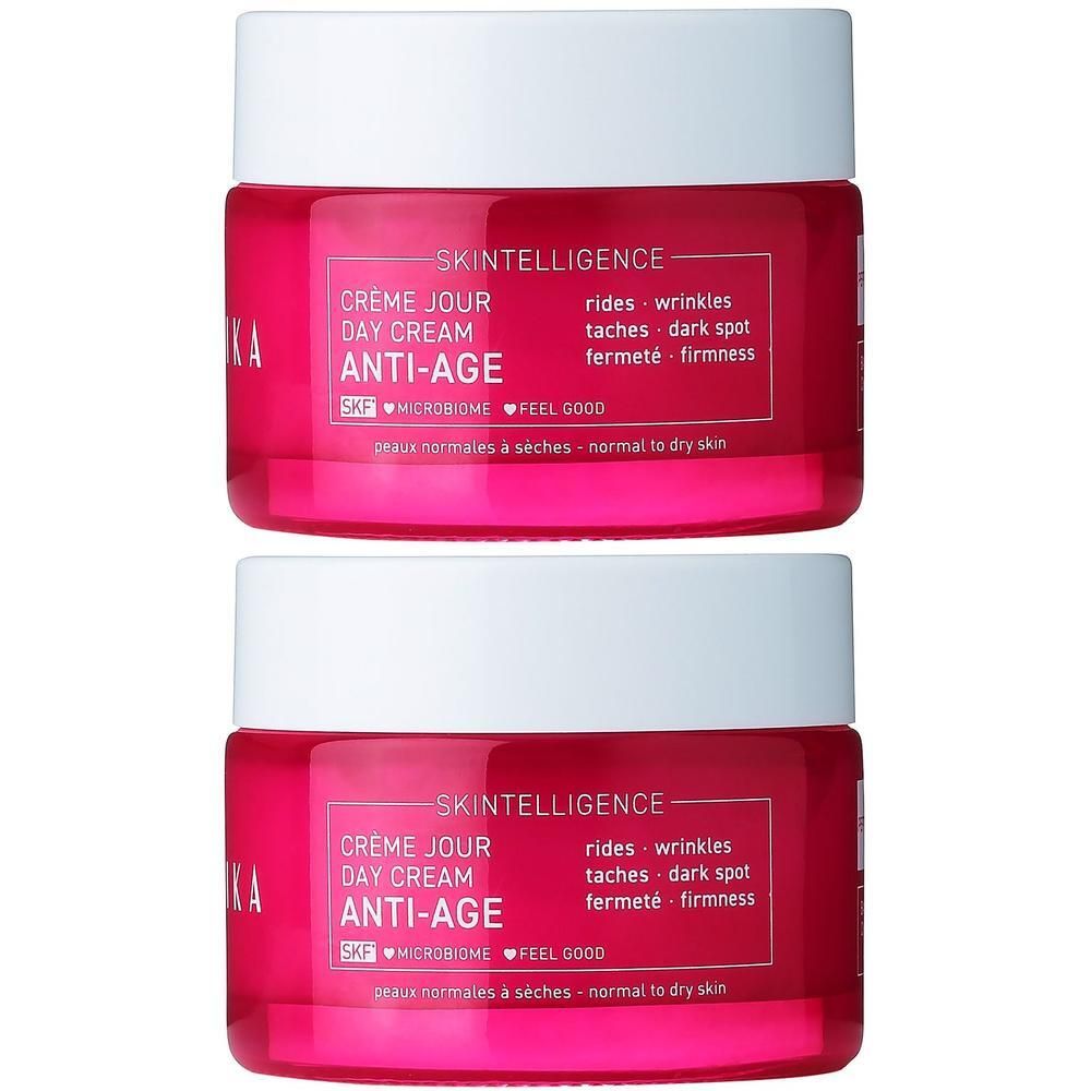 Deux pots de crème de jour anti-âge Talika Skintelligence. Pots roses avec couvercles blancs.