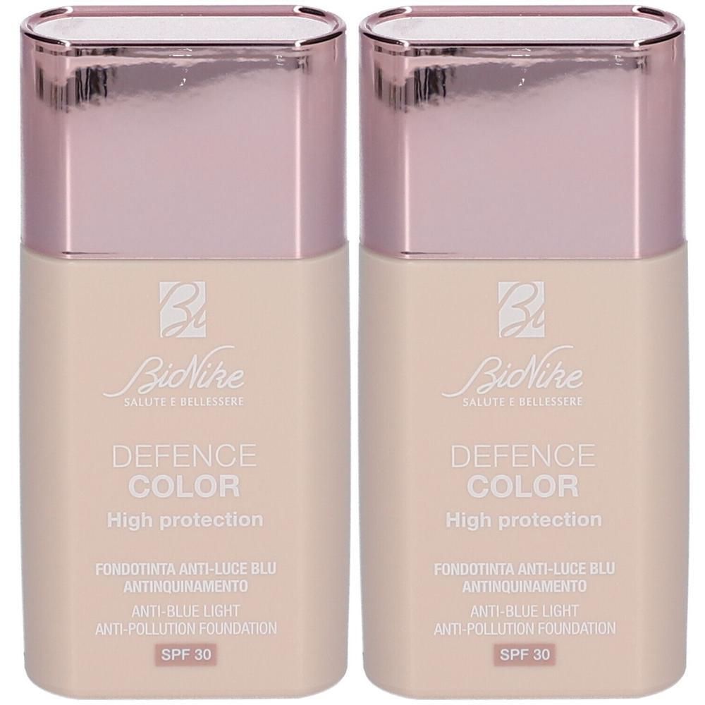Twee BioNike Defence Color High Protection foundations in zandkleur met SPF 30.
