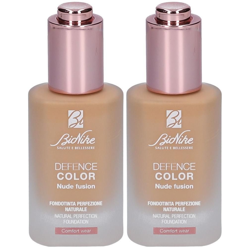 Twee BioNike Defence Color Nude Fusion foundations in Hazelnut met roségouden doppen.