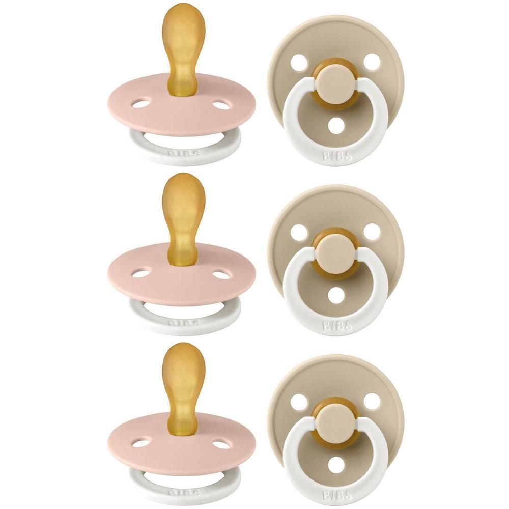 Trois tétines BIBS roses et trois beiges avec tétine en caoutchouc naturel et anneau blanc.