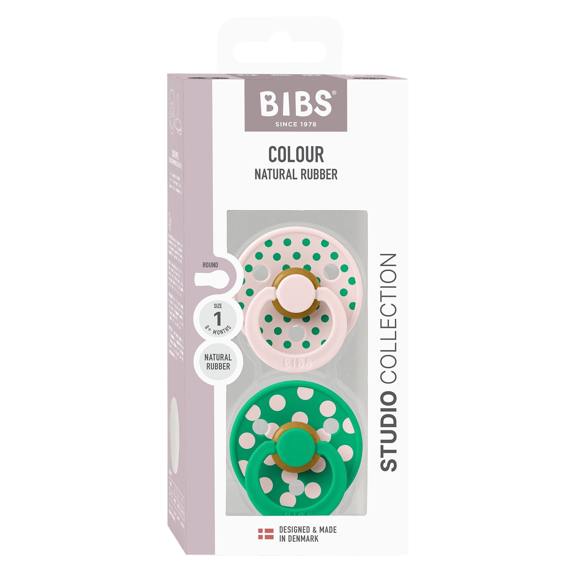 Emballage BIBS Studio Collection avec deux sucettes : une rose et une verte à pois blancs.