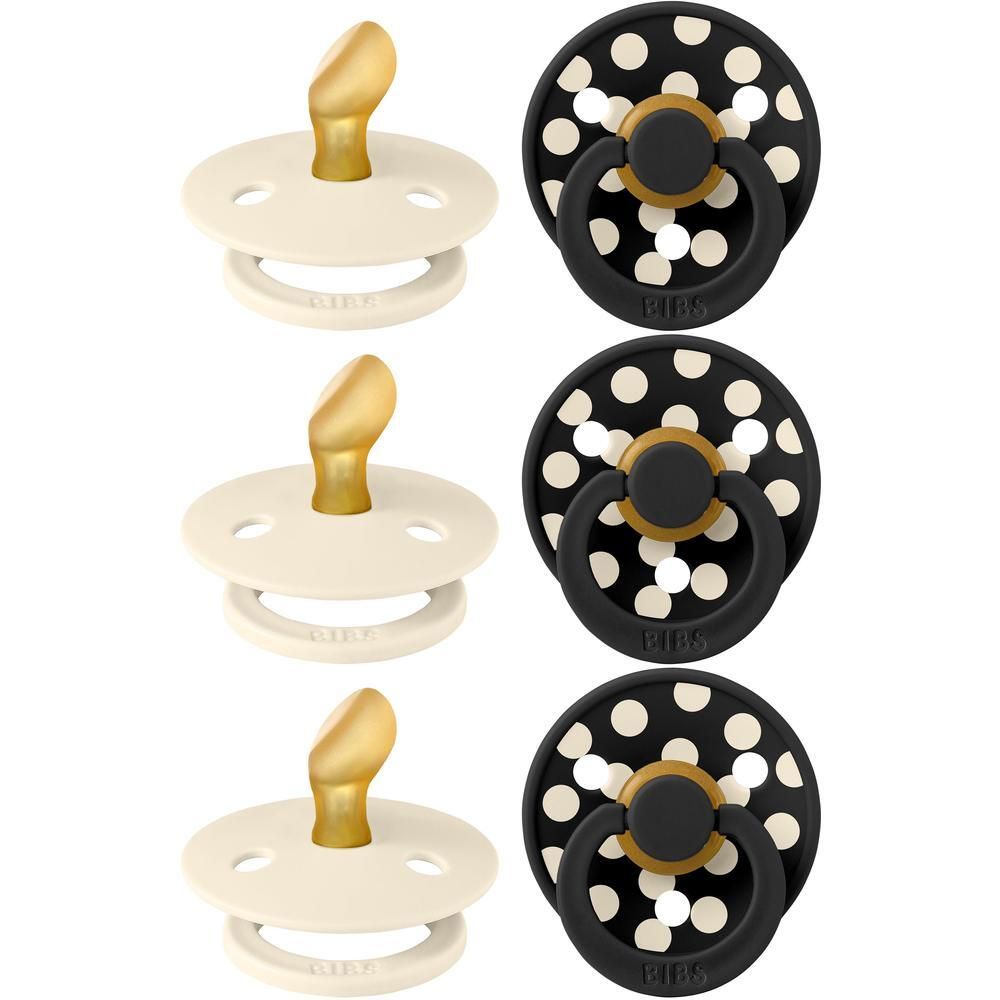 Drie crème en drie zwart-gestipte fopspenen met gouden handvat.