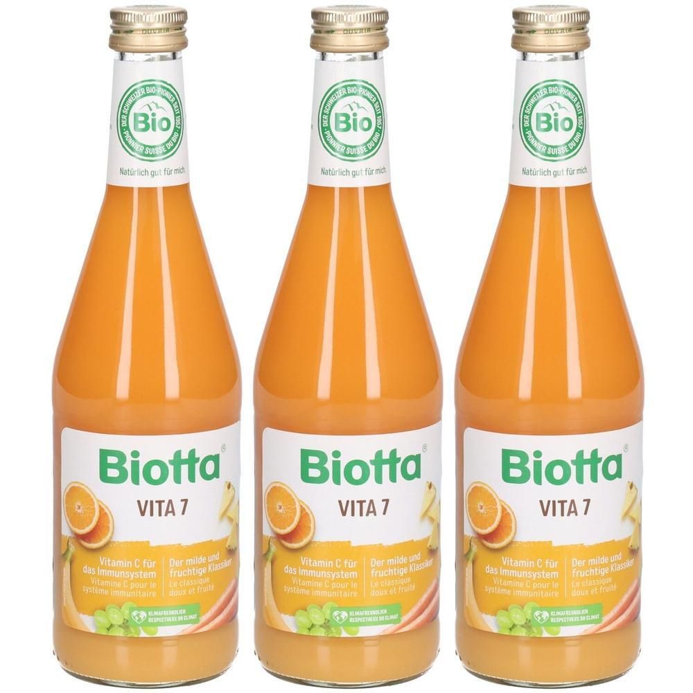 Trois bouteilles de jus de carotte Biotta VITA 7 avec sceau Bio. Symboles orange et raisin.