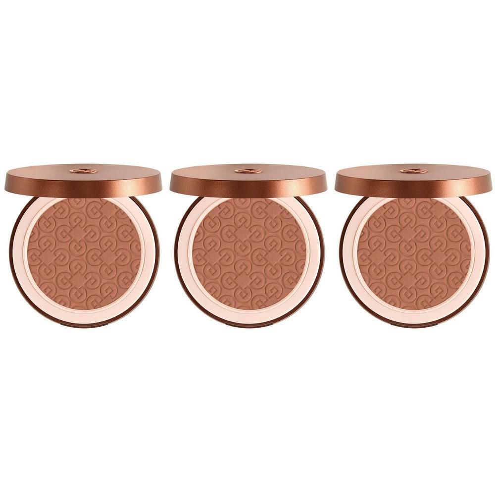 Drie geopende bronzing poeder compacts met reliëfpatroon.