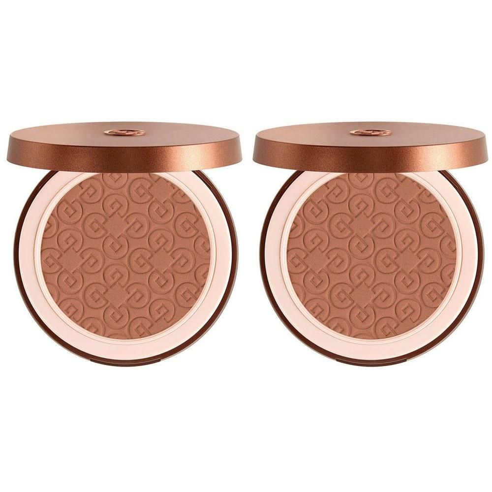 Twee geopende bronzing poeder compacts met reliëfpatroon.
