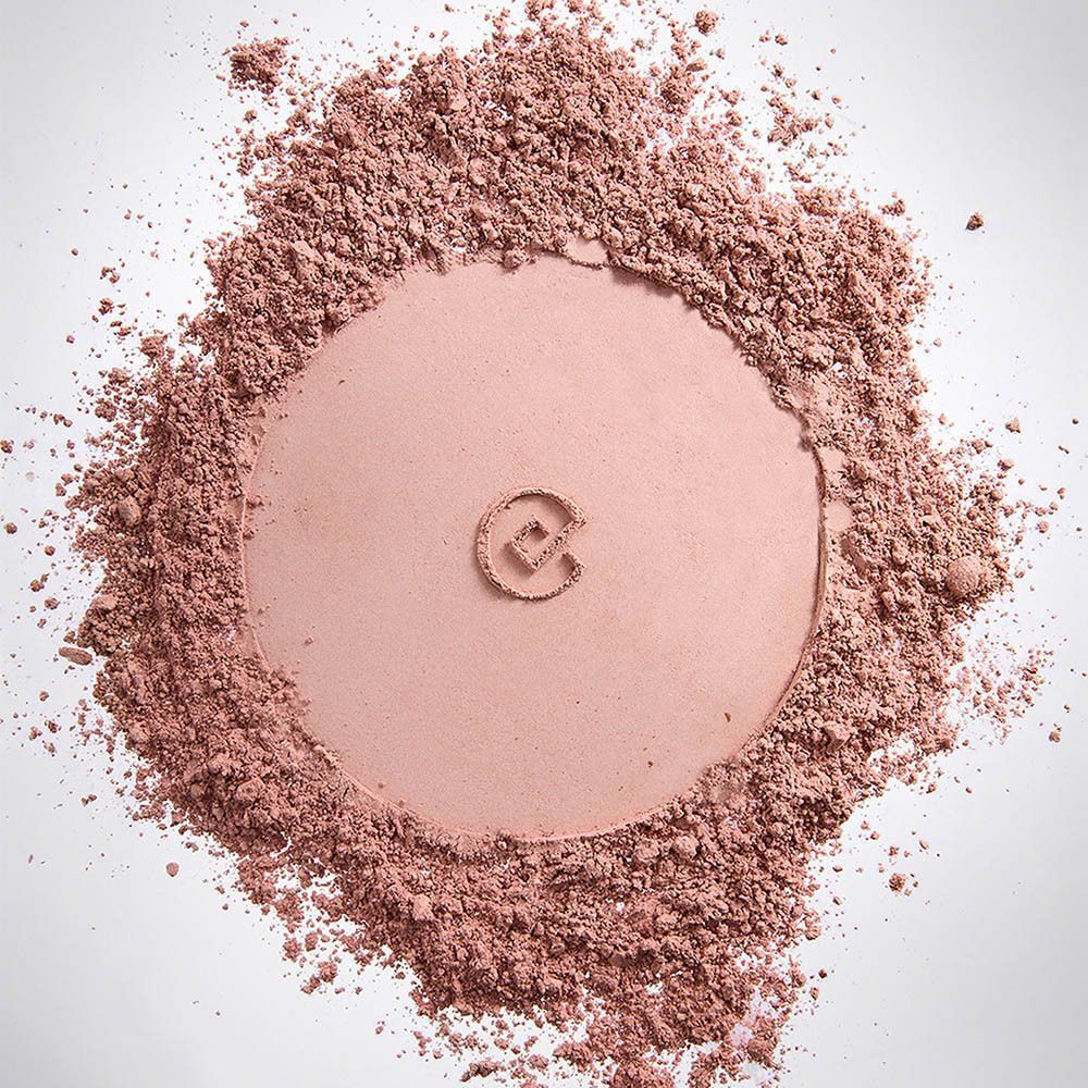 Poudre rose dispersée avec une empreinte circulaire et le logo Collistar au centre.