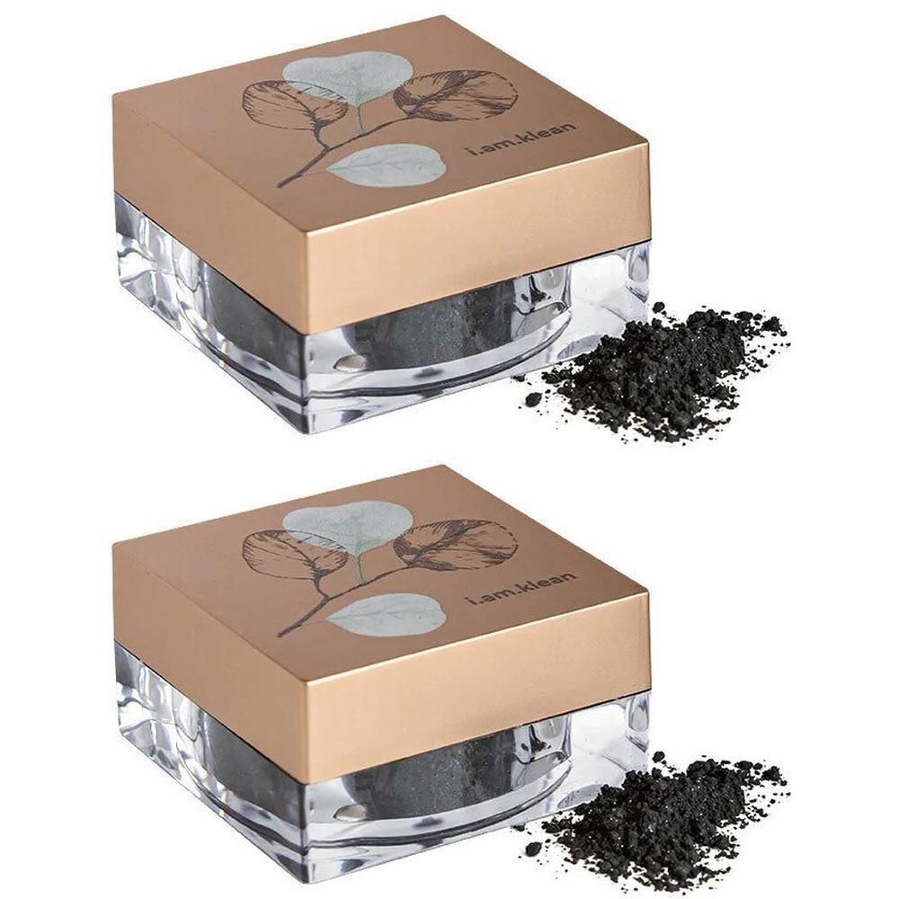 Deux pots de fard à paupières minéral noir. Couvercles dorés avec motif de feuilles et logo de la marque.