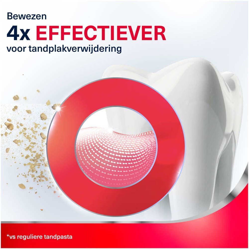 Close-up van een tand met een rode cirkel die deeltjes toont.