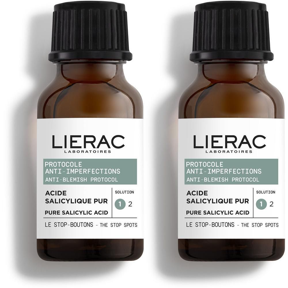 Deux flacons en verre brun avec bouchon compte-gouttes, protocole Lierac Anti-Imperfections à l'acide salicylique.