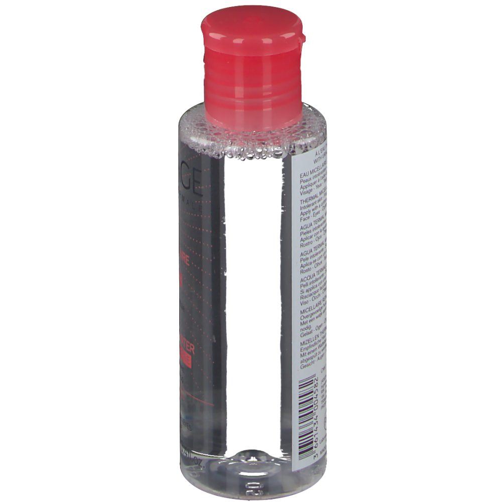 Flacon transparent avec bouchon rouge. Étiquette avec informations produit. Code-barres et indication de volume.