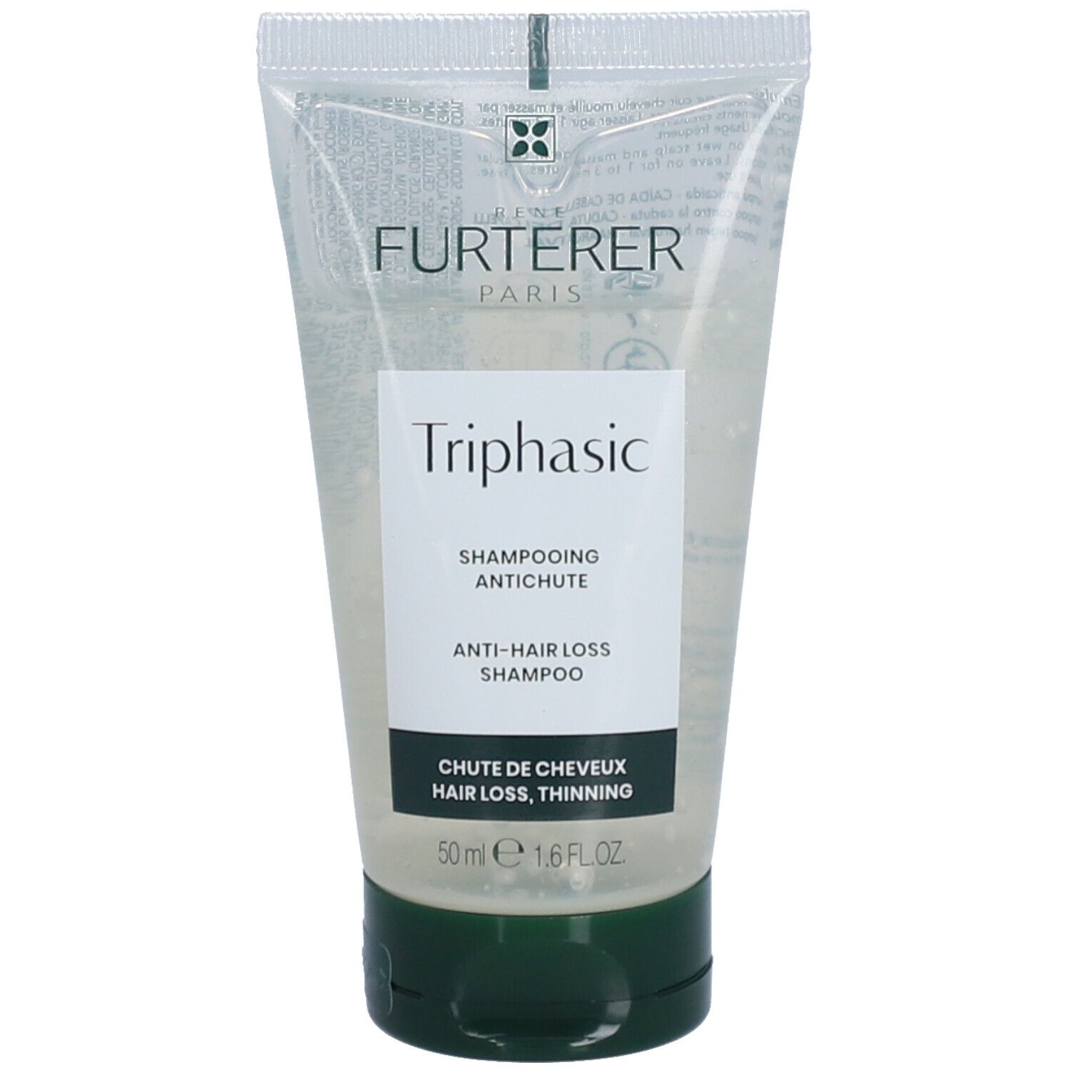 Tube transparent avec bouchon vert. Inscription "FURTERER PARIS" et "Triphasic". Texte : Shampooing antichute.