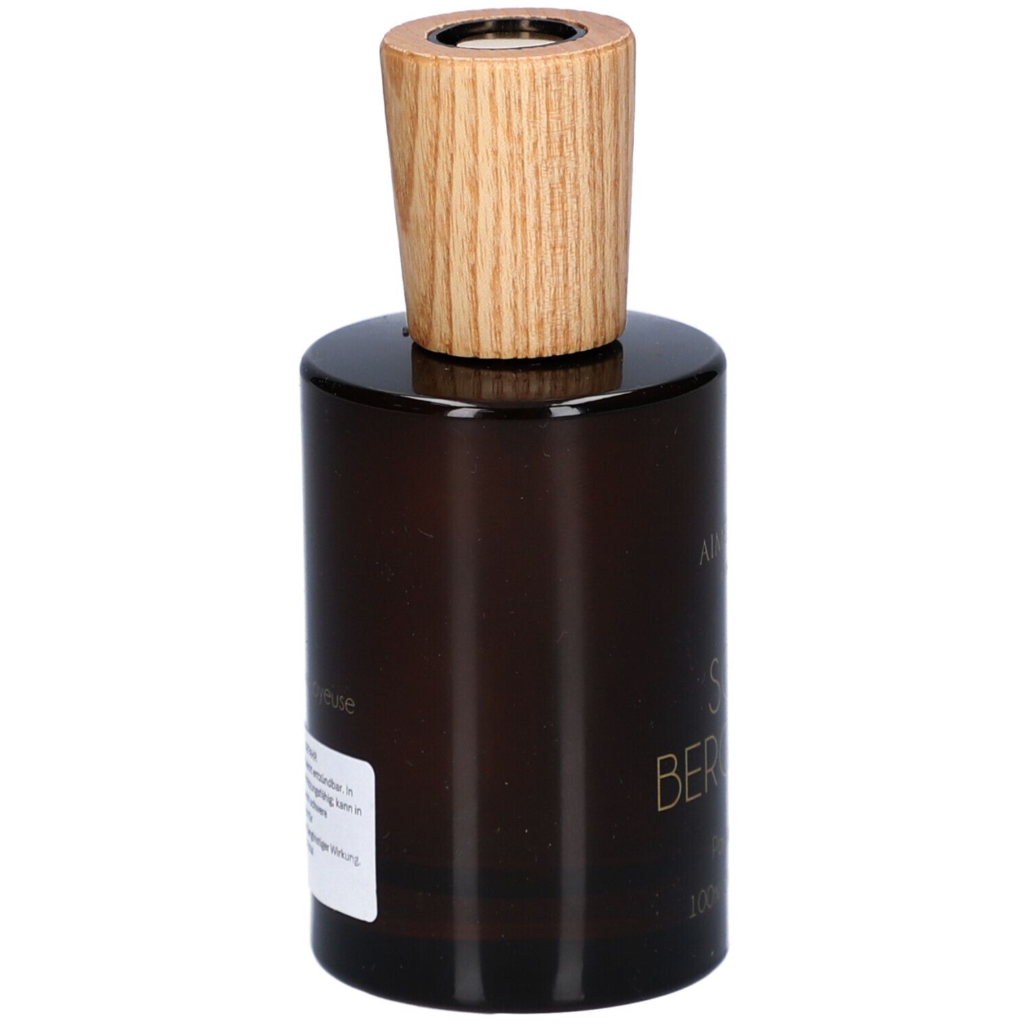Bruine glazen fles met houten dop. Etiket op de achterkant met tekst. Productnaam onleesbaar.