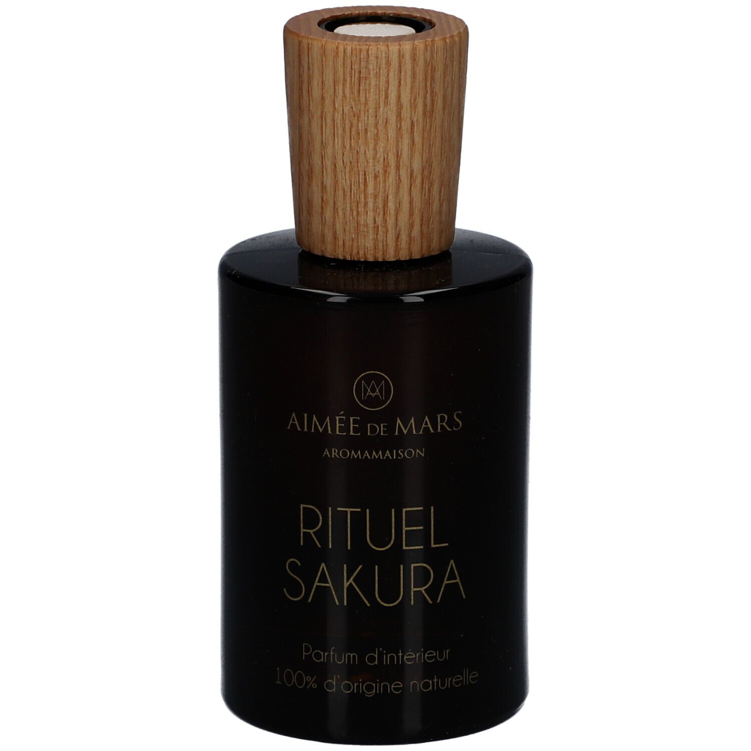 Bruine glazen fles met houten dop. Opschrift: Rituel Sakura, Parfum d'intérieur, 100% d'origine naturelle. Merk: Aimée de Mars.