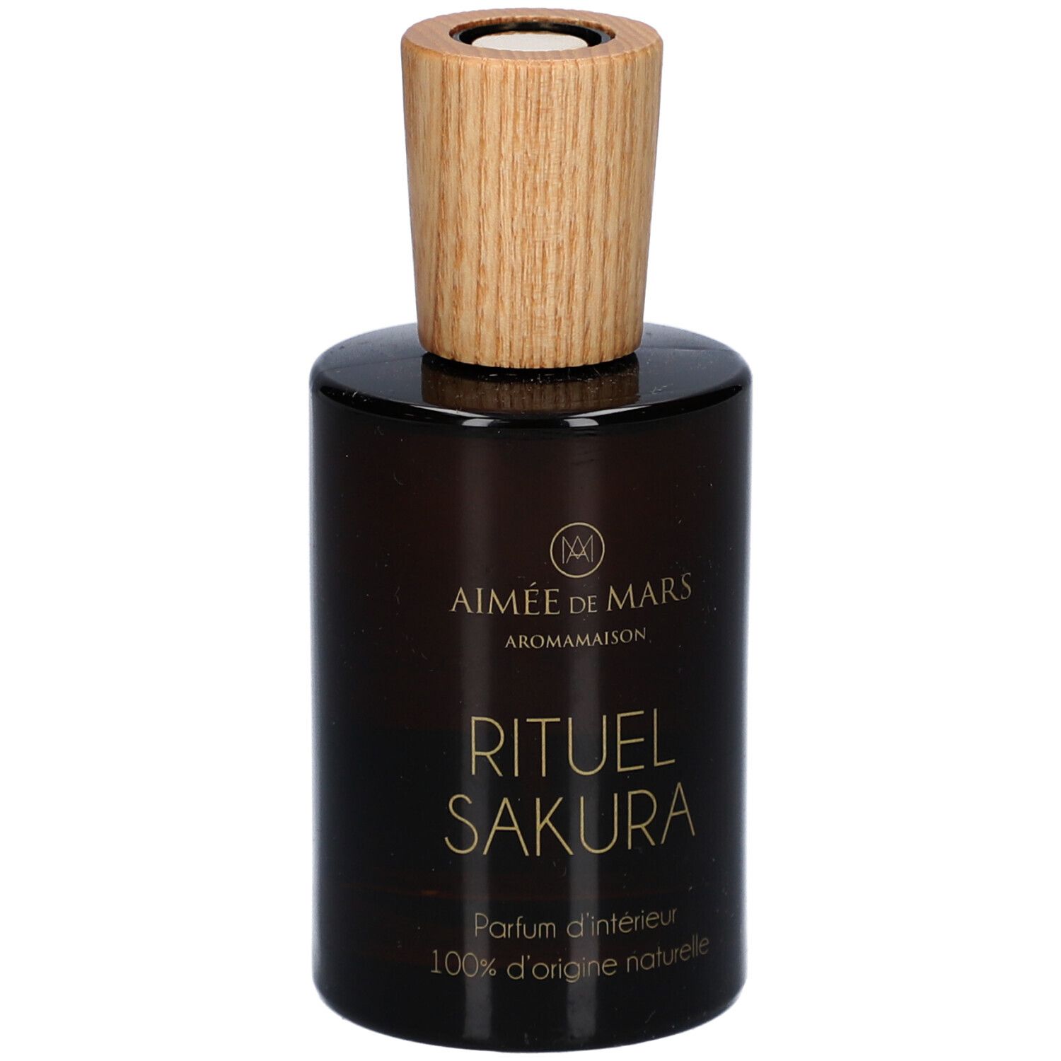 Bruine glazen fles met houten dop. Opschrift: Rituel Sakura, Parfum d'intérieur, 100% d'origine naturelle. Merk: Aimée de Mars.