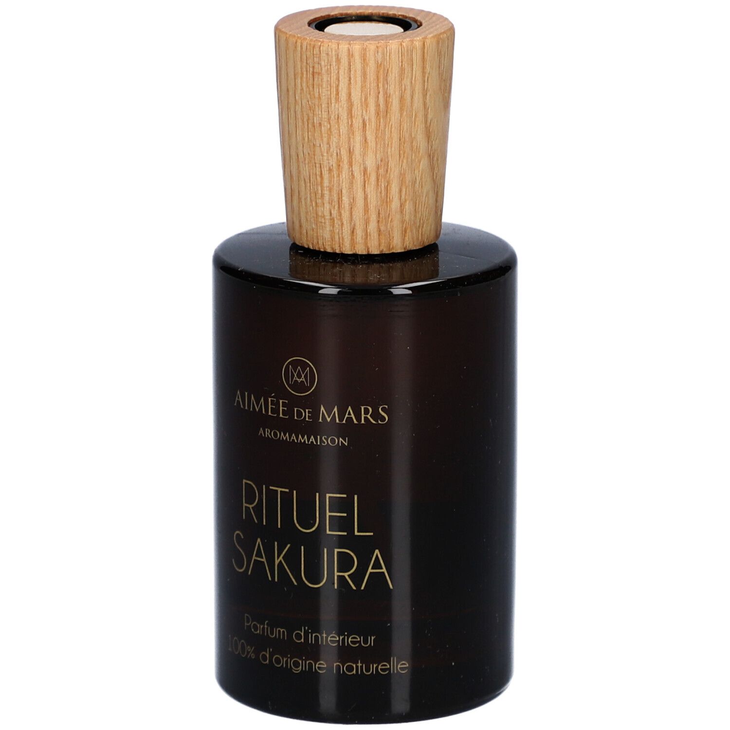 Bruine glazen fles met houten dop. Opschrift: Rituel Sakura, Parfum d'intérieur, 100% d'origine naturelle. Merk: Aimée de Mars.