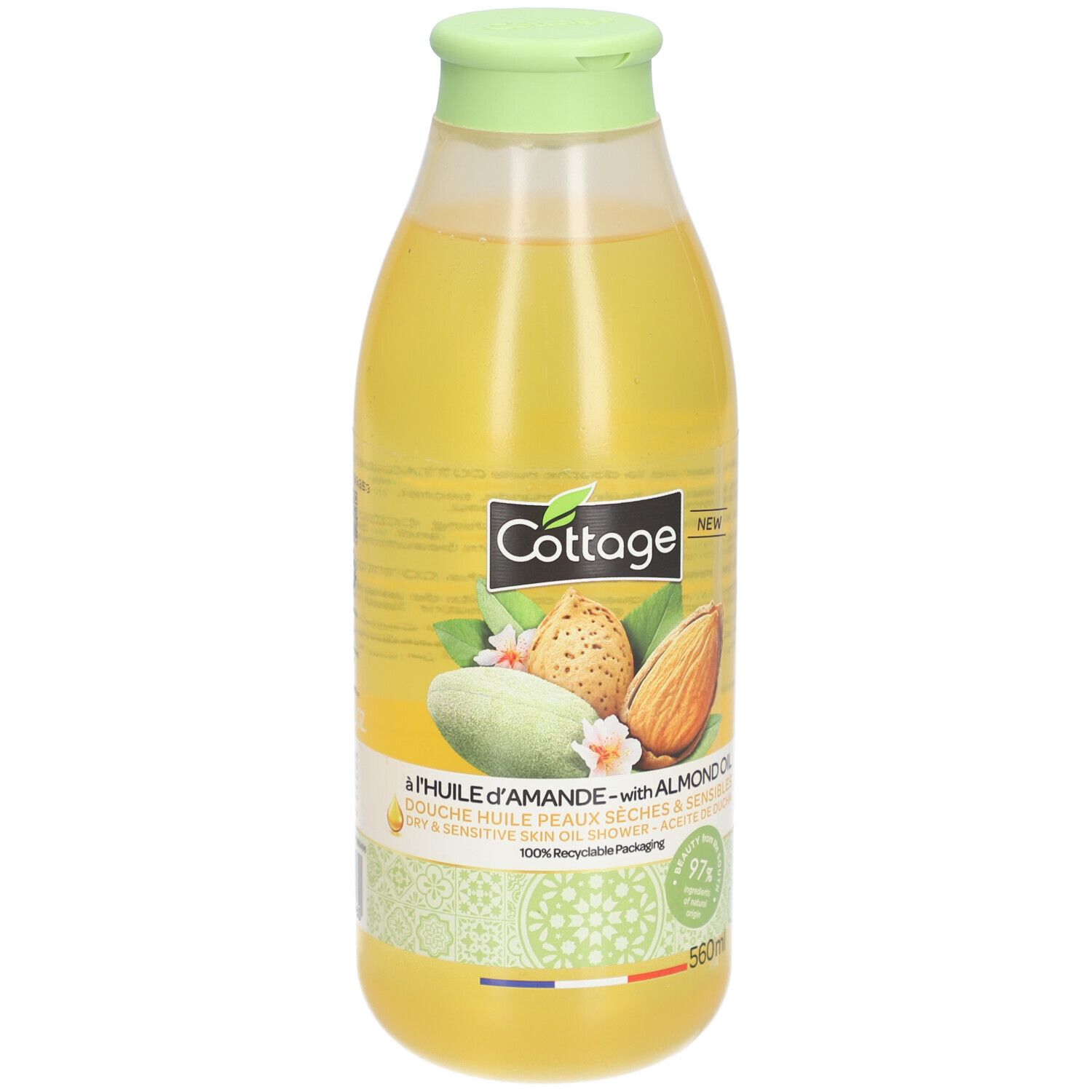 Flacon de douche Cottage à l'huile d'amande. Liquide jaune. Illustrations d'amandes. Bouchon vert. 560ml. Emballage recyclable.